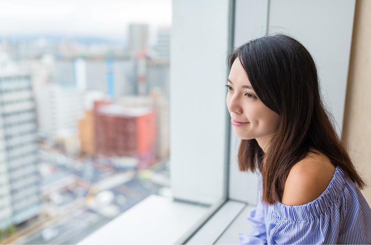 Woman looking out of office window