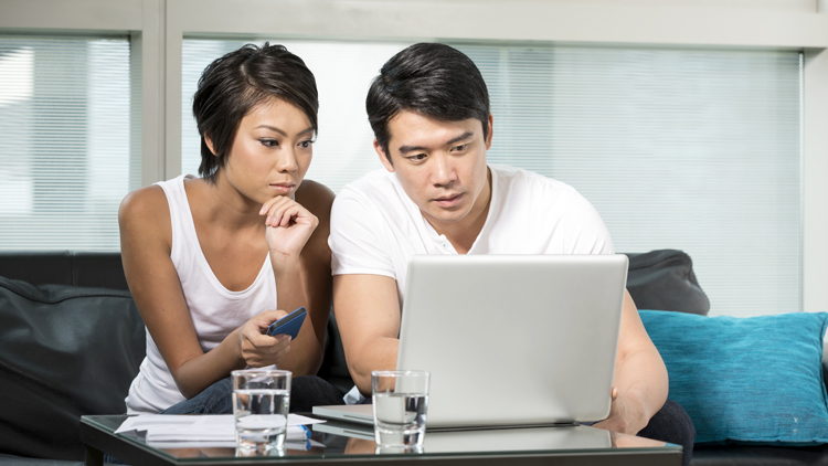 Man and woman looking at a laptop