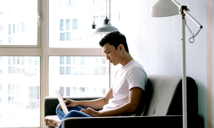 Man sitting on couch with a laptop
