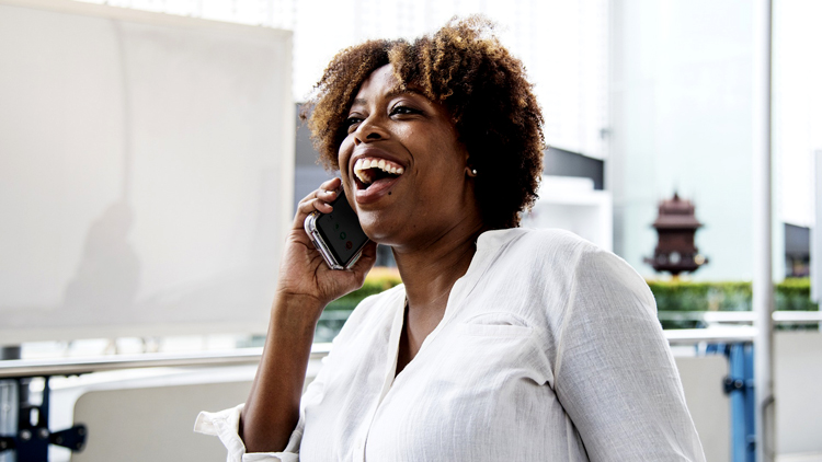 Woman speaking on the phone while smiling