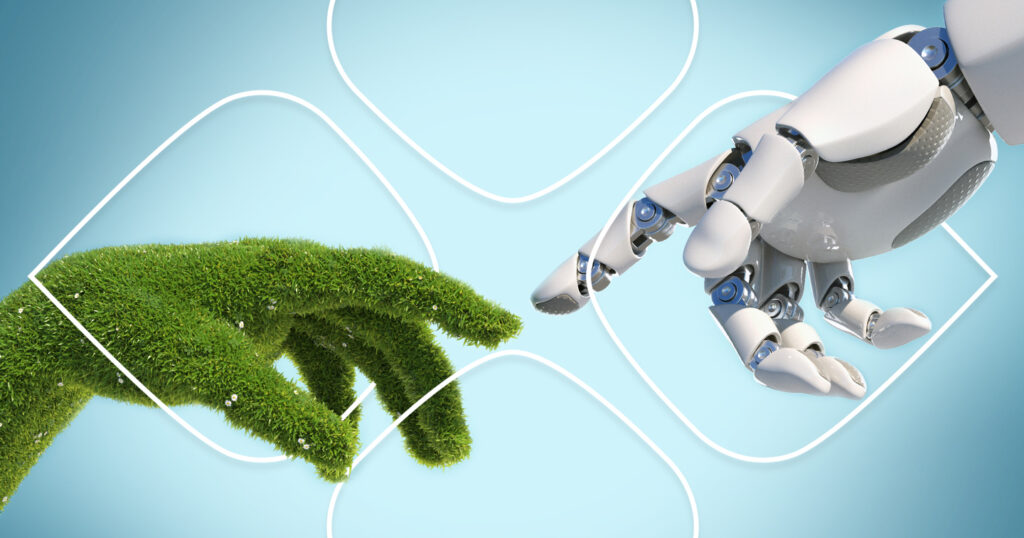 Two hands, one a robot, one covered in grass